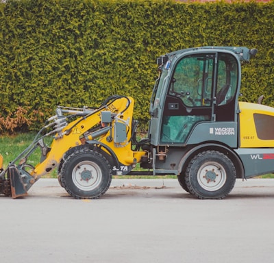 a small construction vehicle parked on the side of the road