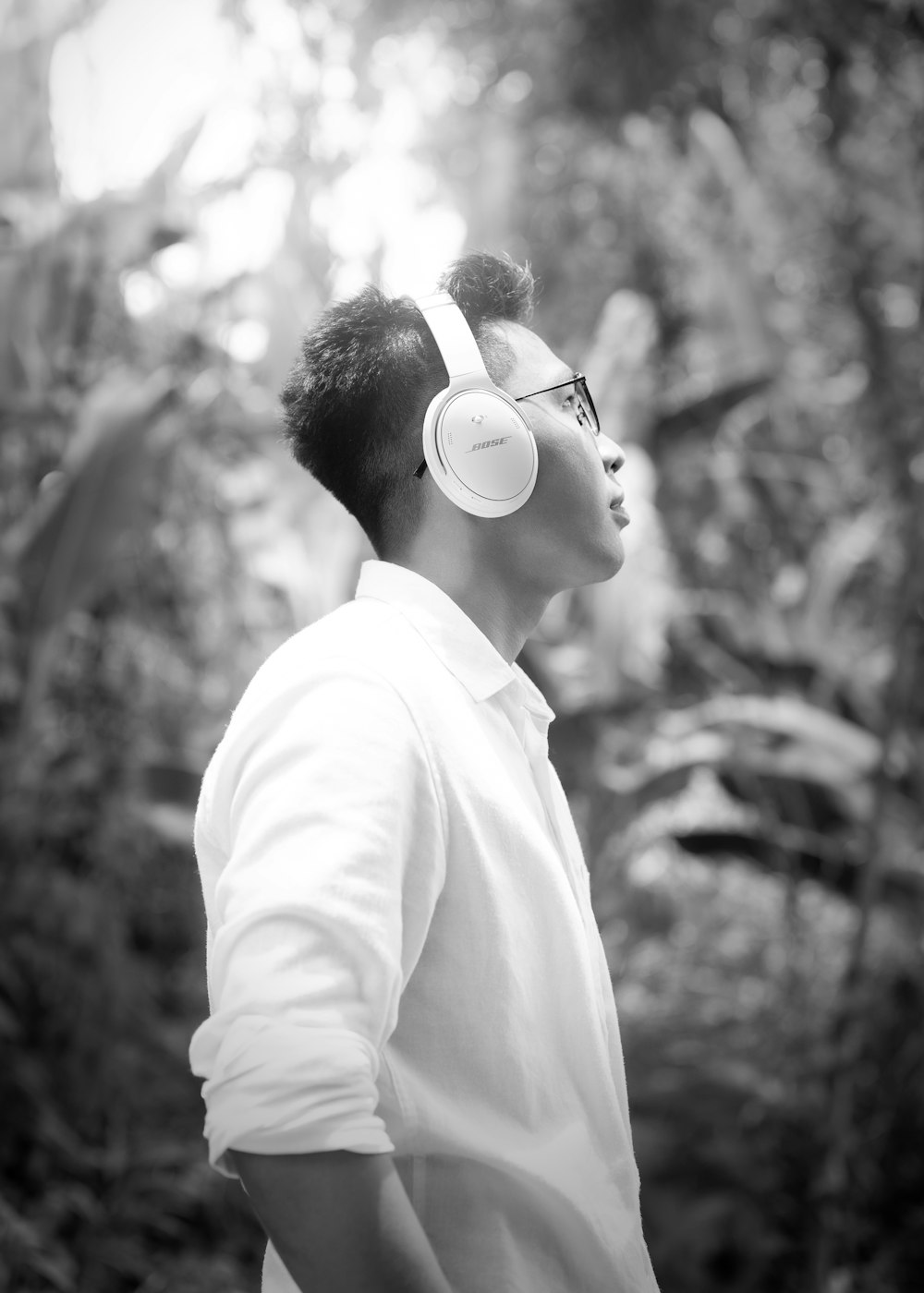 a man wearing headphones in a forest