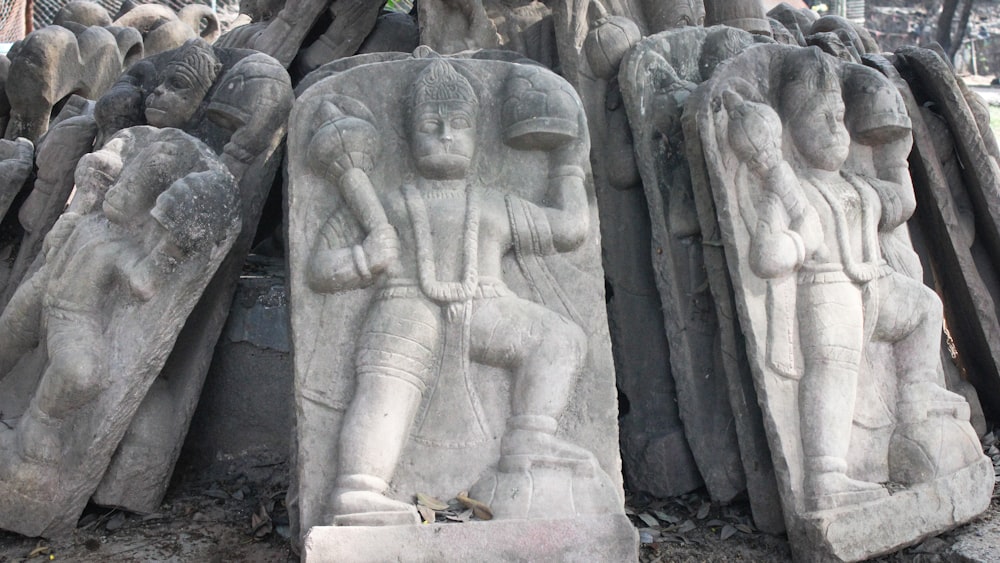 a statue of a man and a woman surrounded by other statues