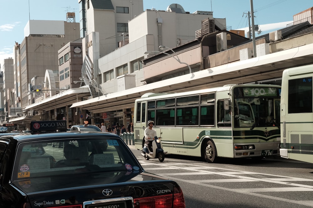 a city street filled with traffic next to tall buildings