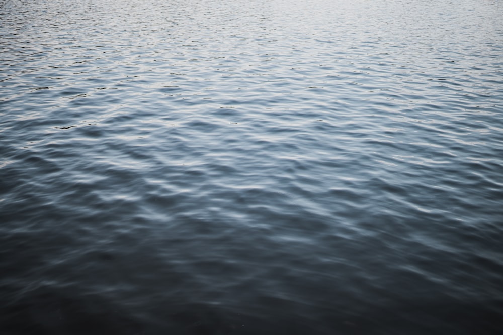 a large body of water with a boat in the distance