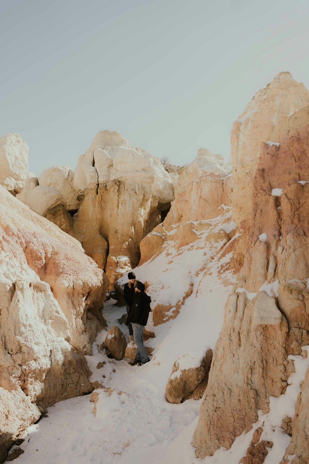 a man walking up a snow covered mountain