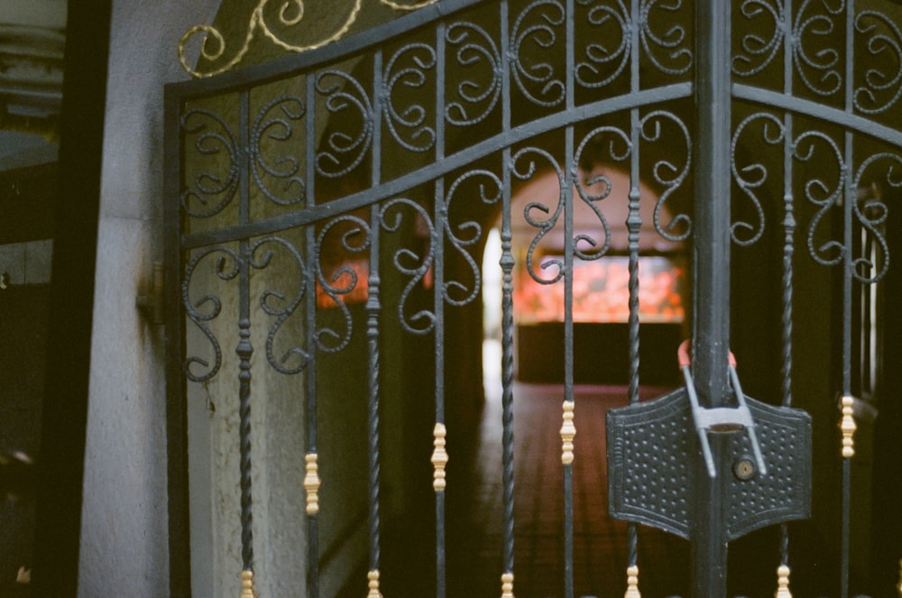 an iron gate with a clock on it