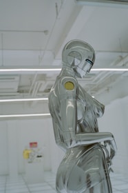 a robot sitting on a chair in a room