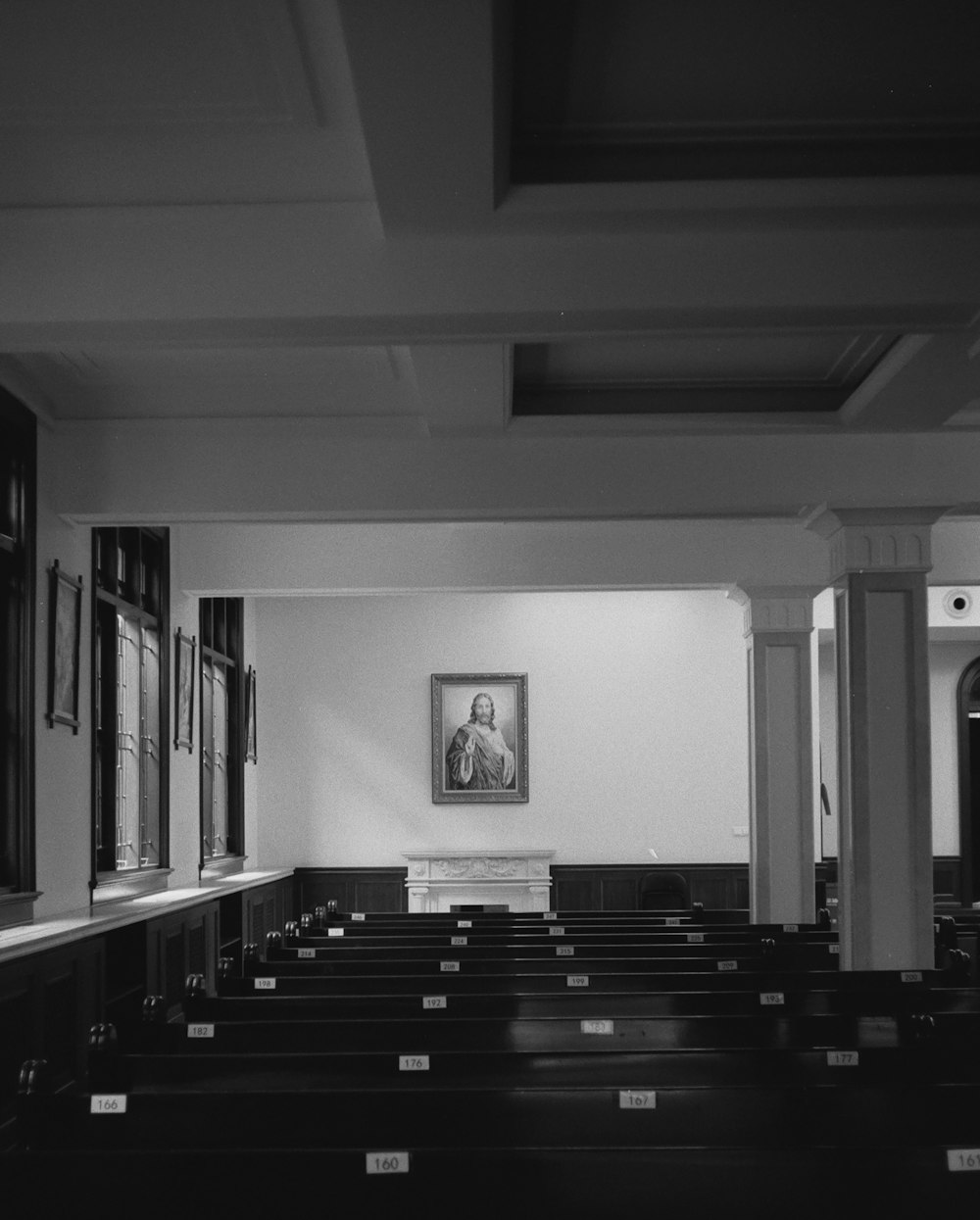 a black and white photo of a church with pews