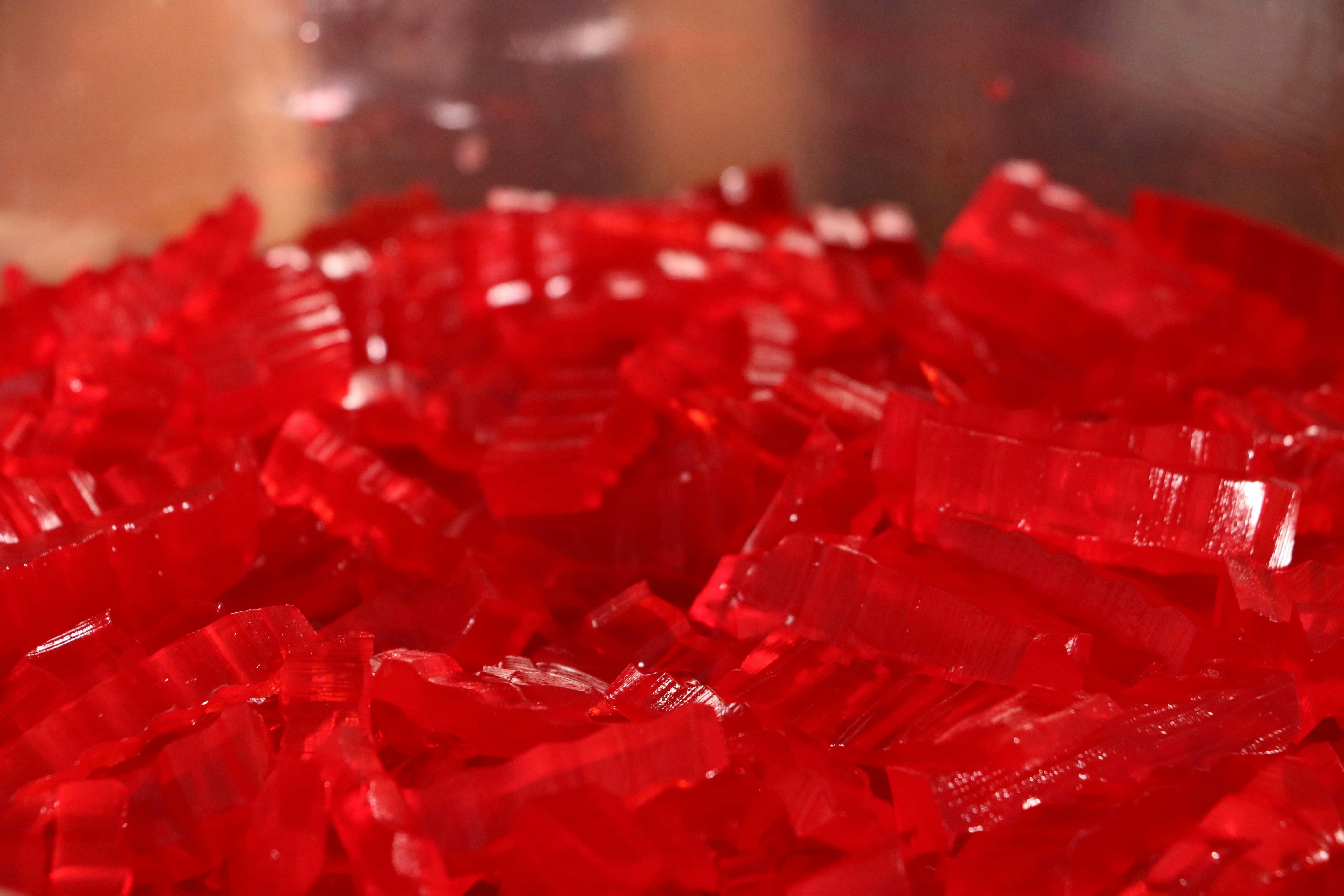 a close up of a bowl of red glass