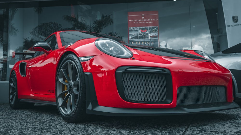 a red sports car parked in front of a building