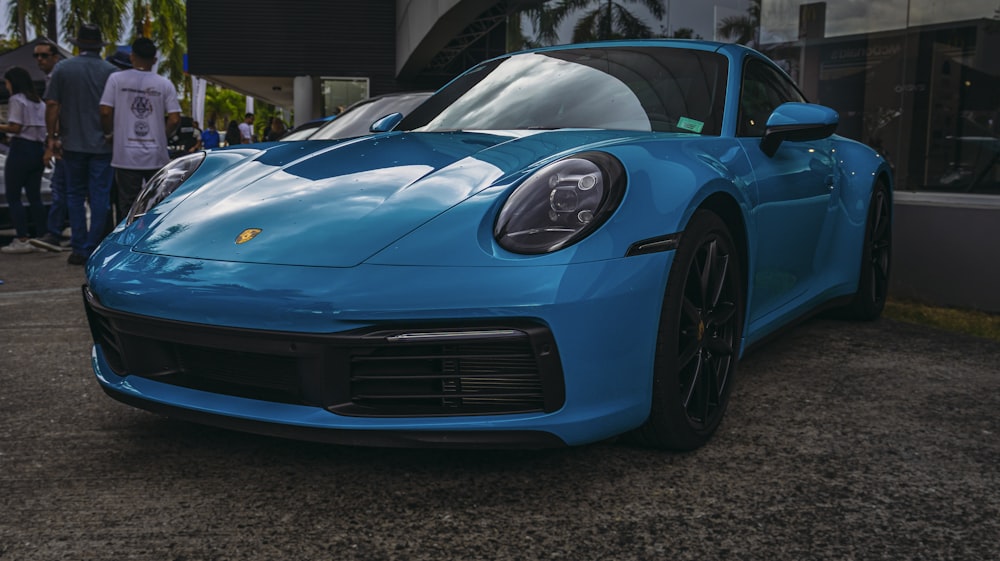 a blue sports car parked in a parking lot