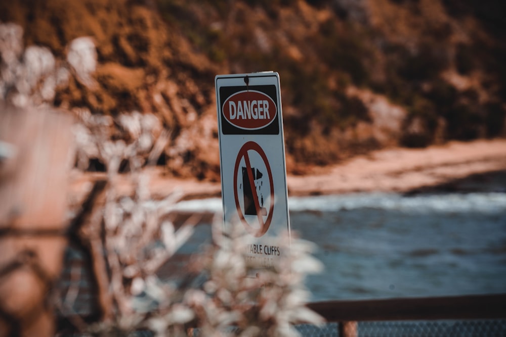 a sign warning of danger on the side of the road