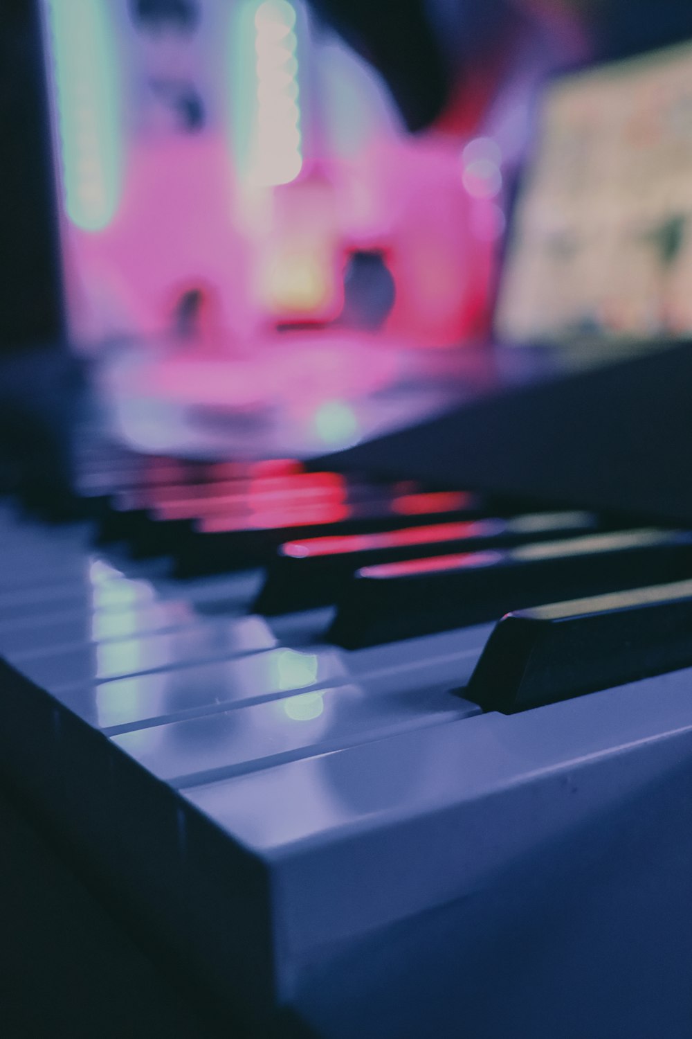 a close up of a piano keyboard with a blurry background