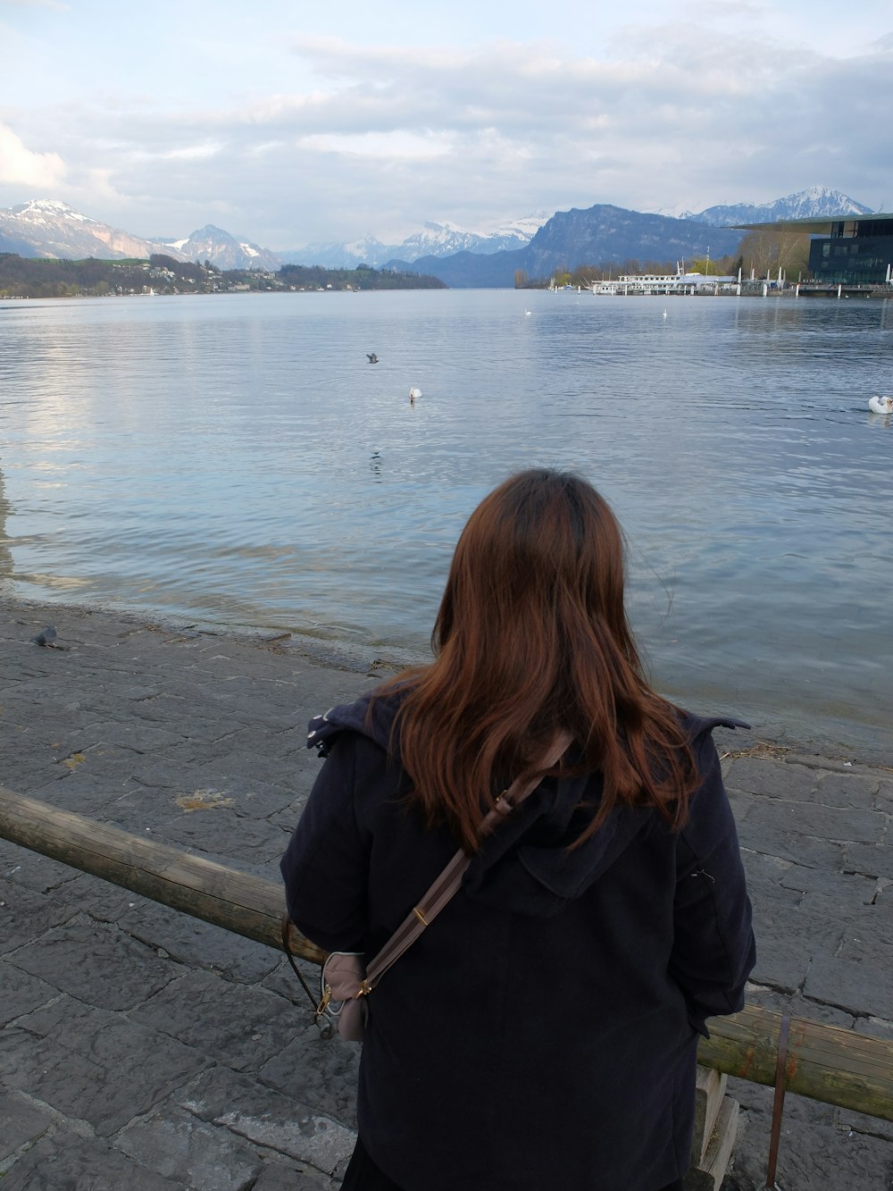 a woman looking out over a body of water