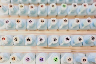 Rows of labeled chemical bottles on shelves in a clean, organized laboratory setting.