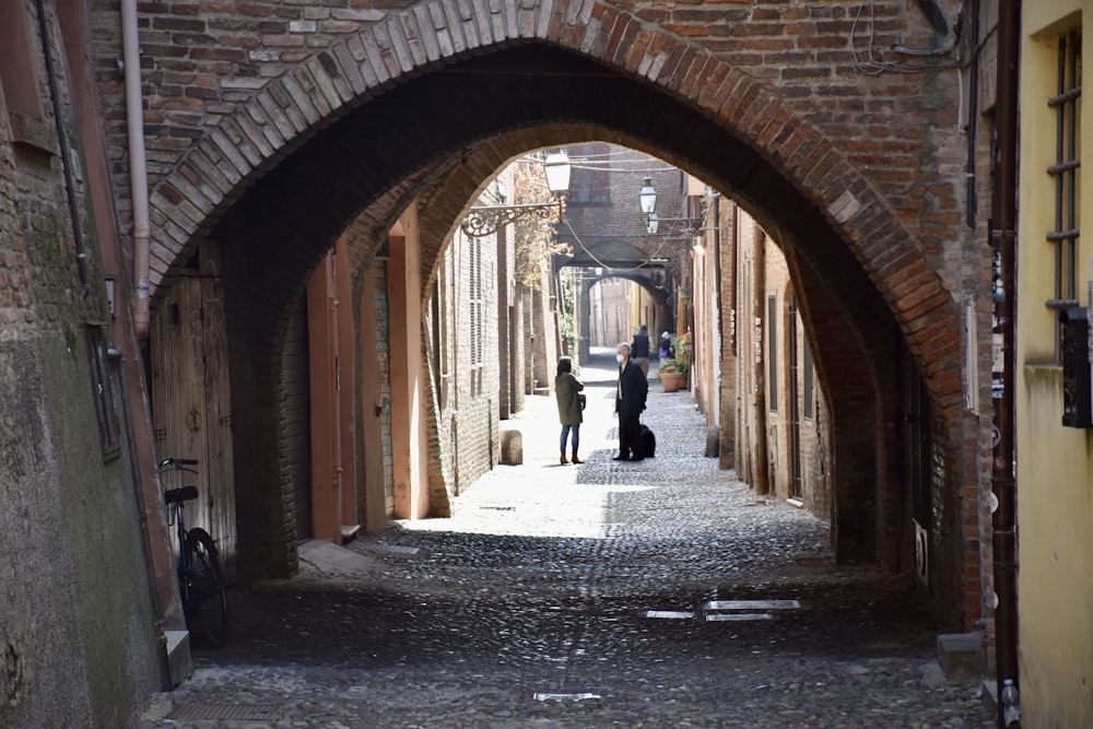 a couple of people that are walking down a street