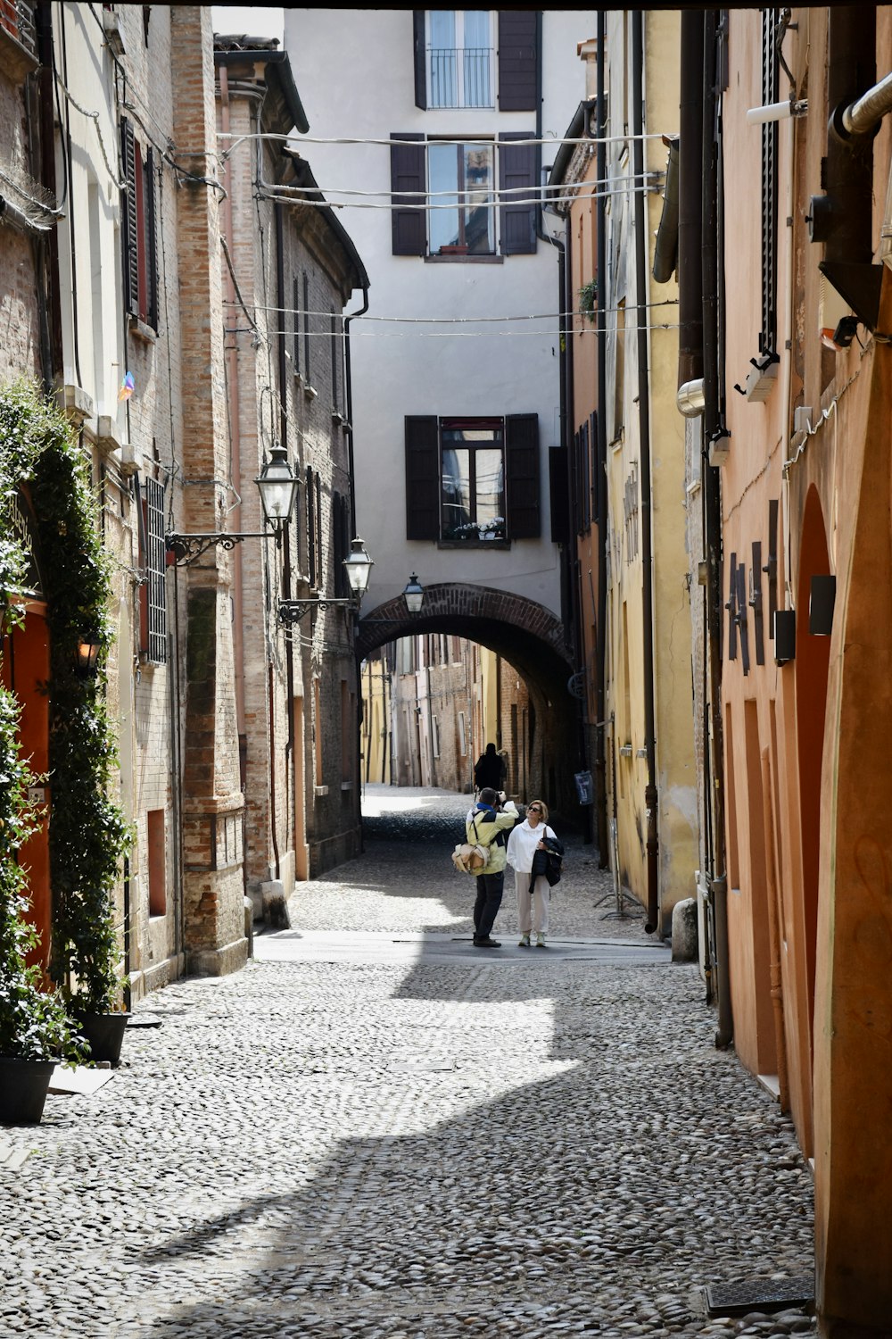 a couple of people that are walking down a street