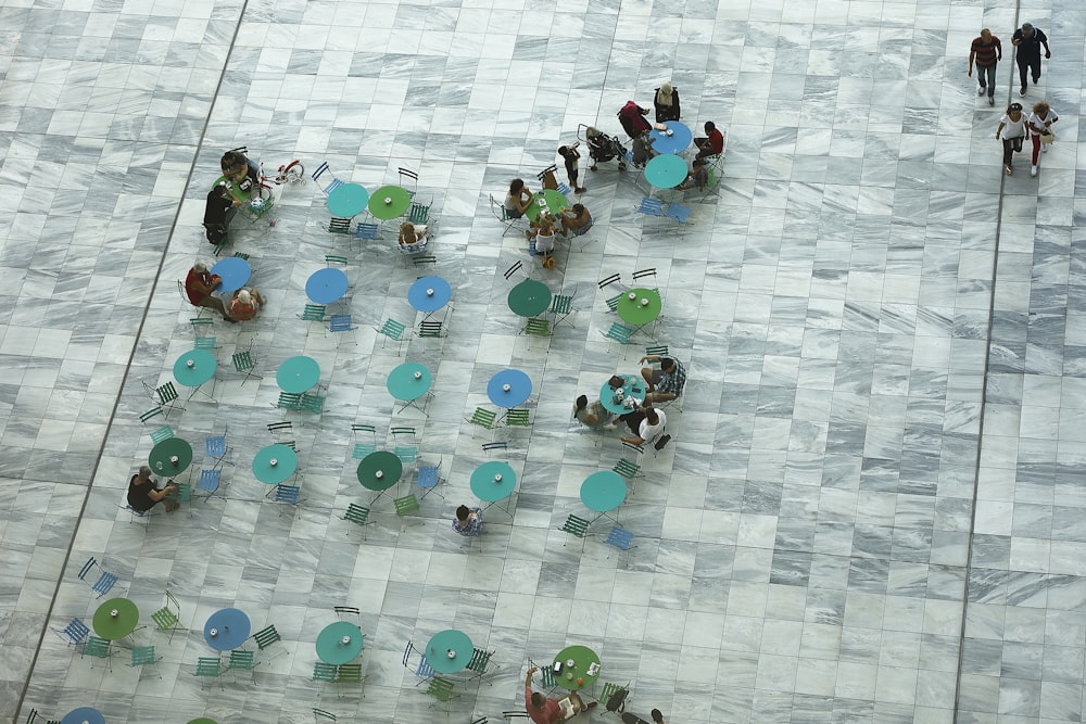 a group of people sitting around tables and chairs