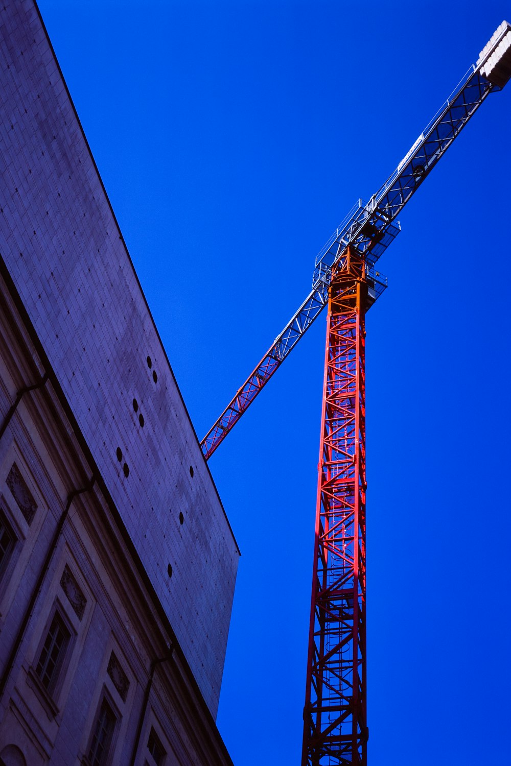 a tall tower with a crane on top of it