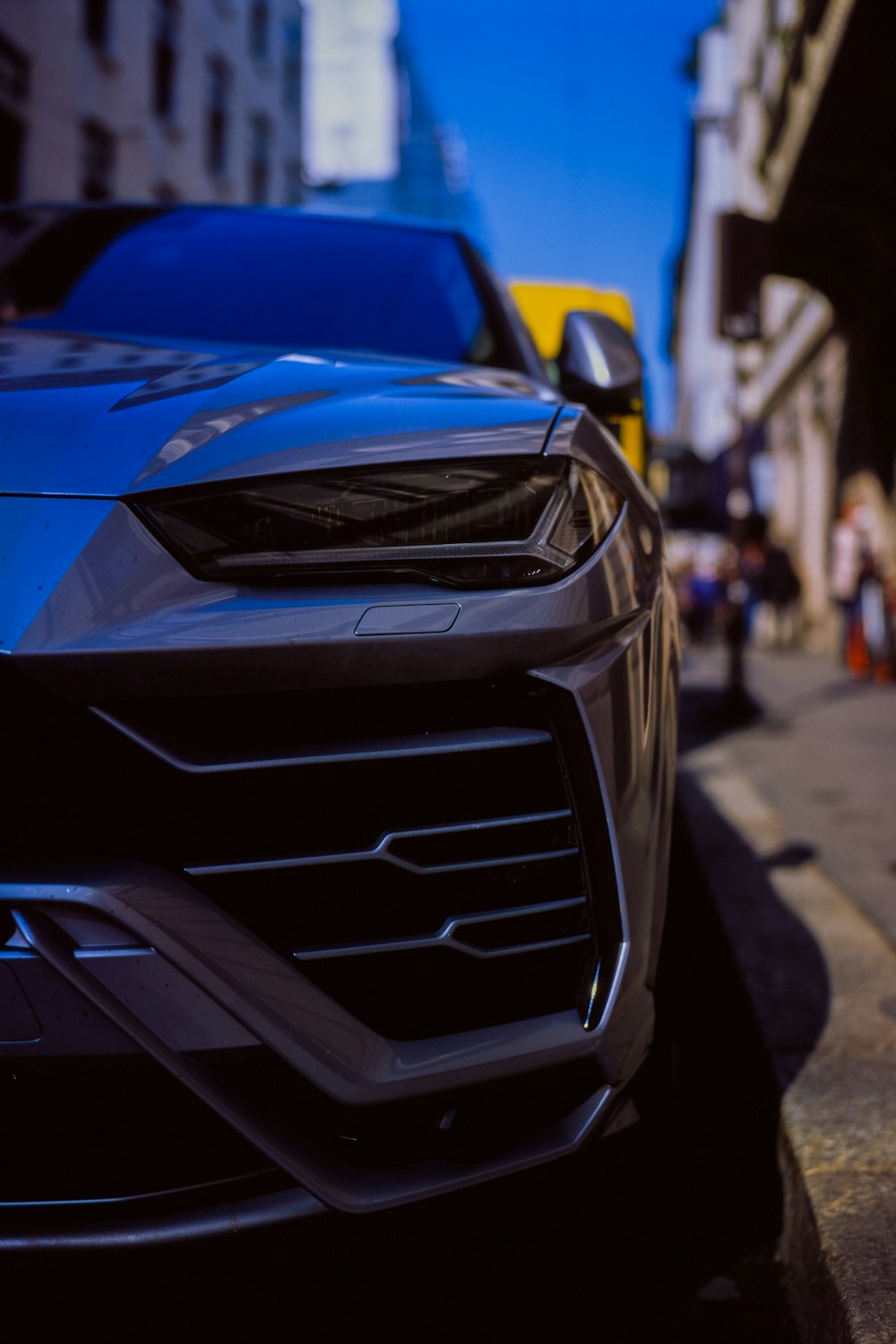 a blue sports car parked on the side of the road