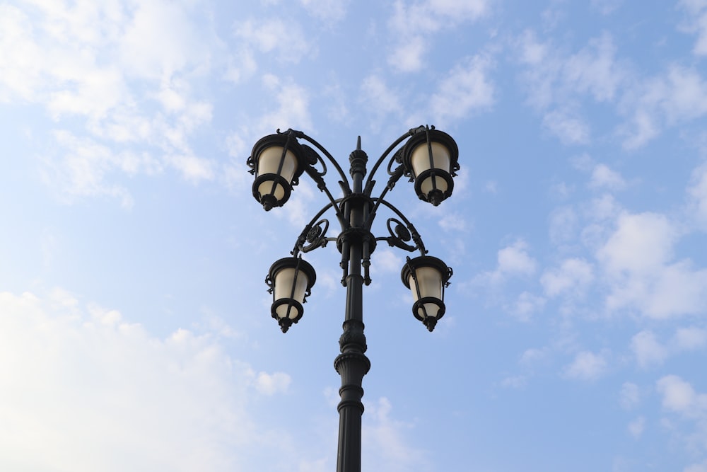 a lamp post with four lights on top of it