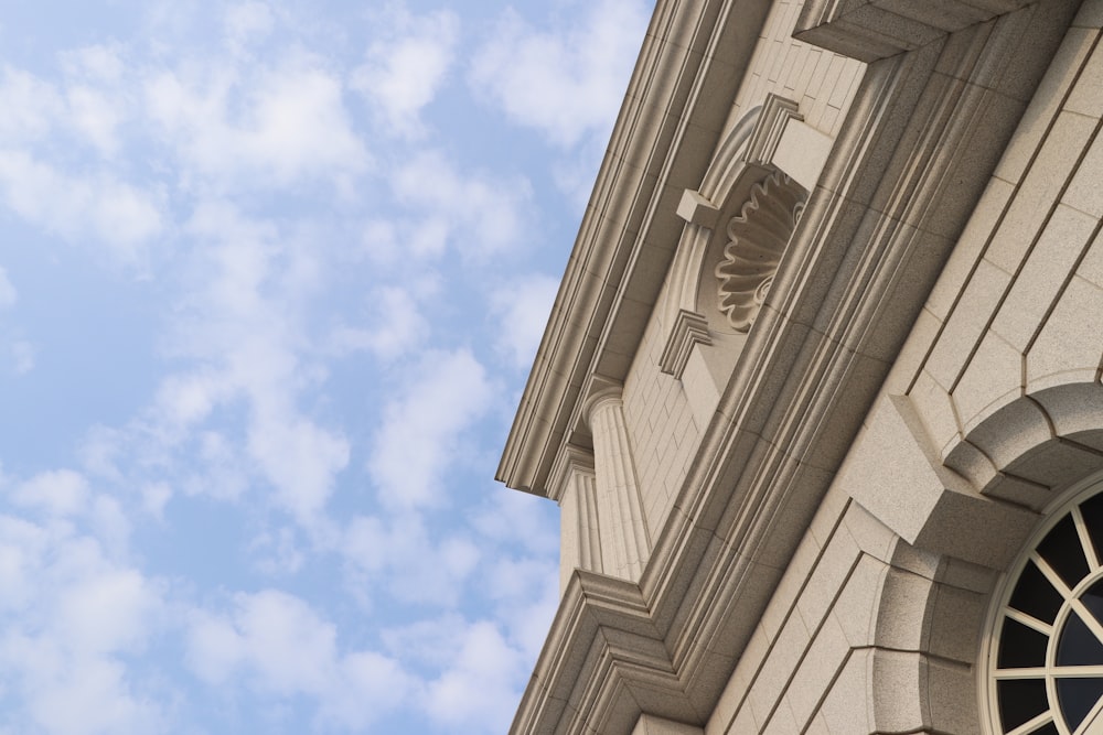 a clock on the side of a building with a sky background