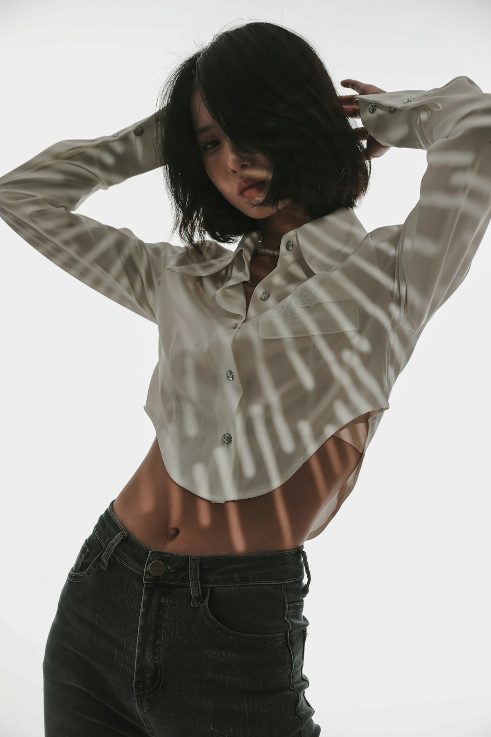 a woman in a white shirt and black jeans