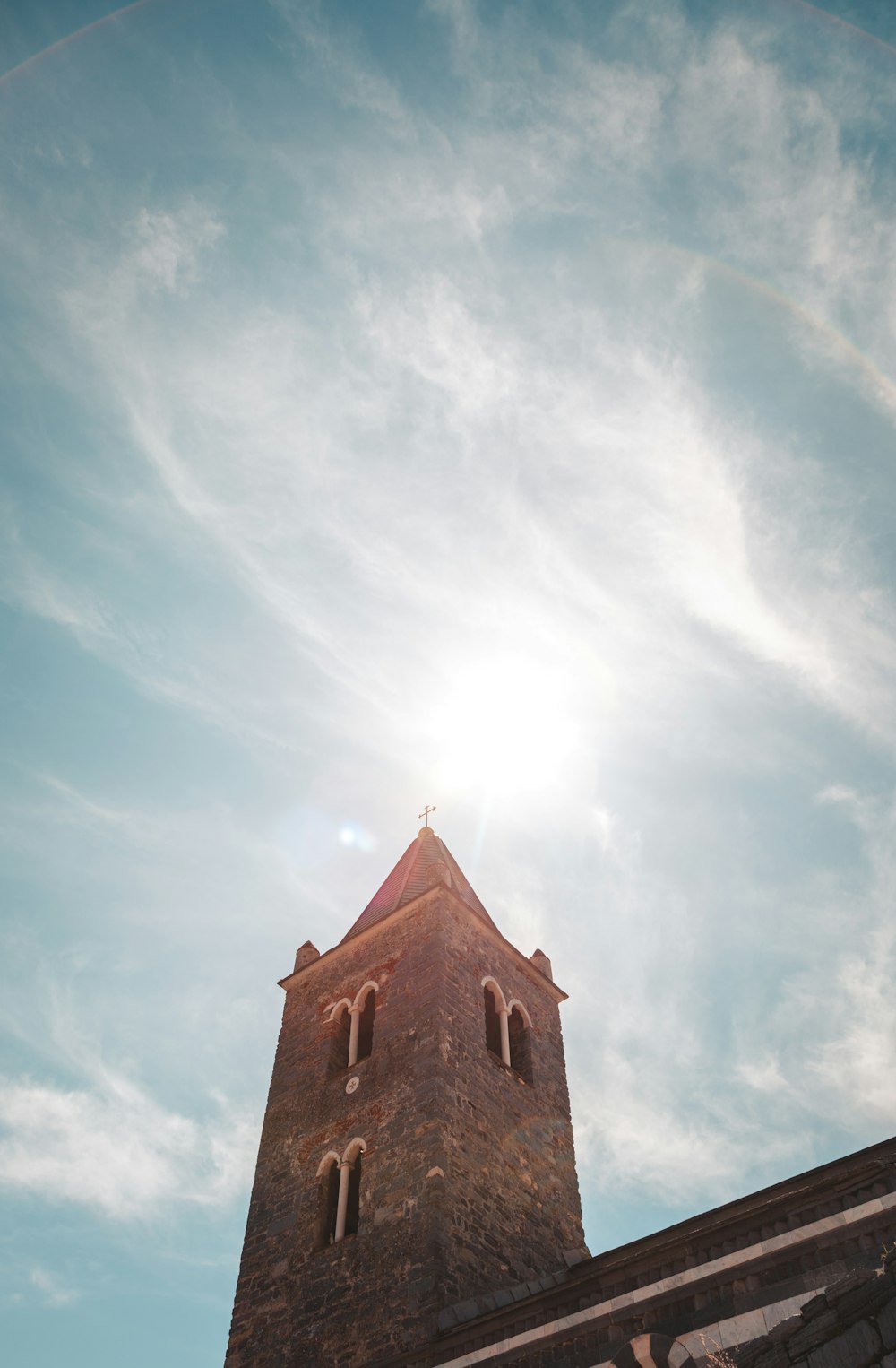 a very tall brick building with a clock on it's side