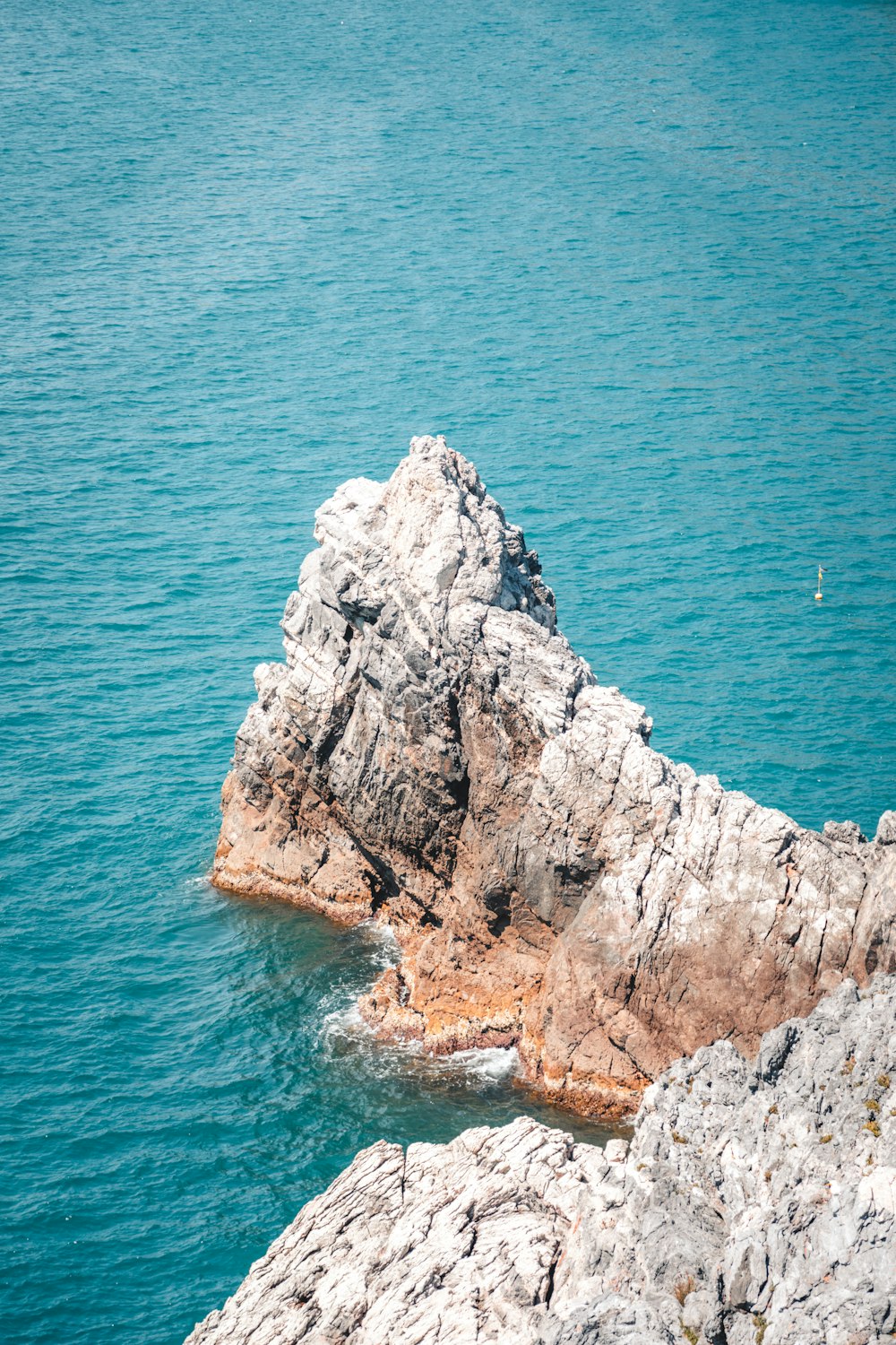 a rock outcropping in the middle of a body of water