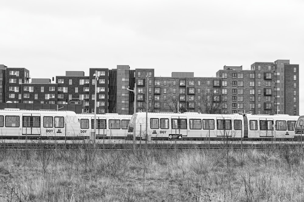 a black and white photo of a train in a city