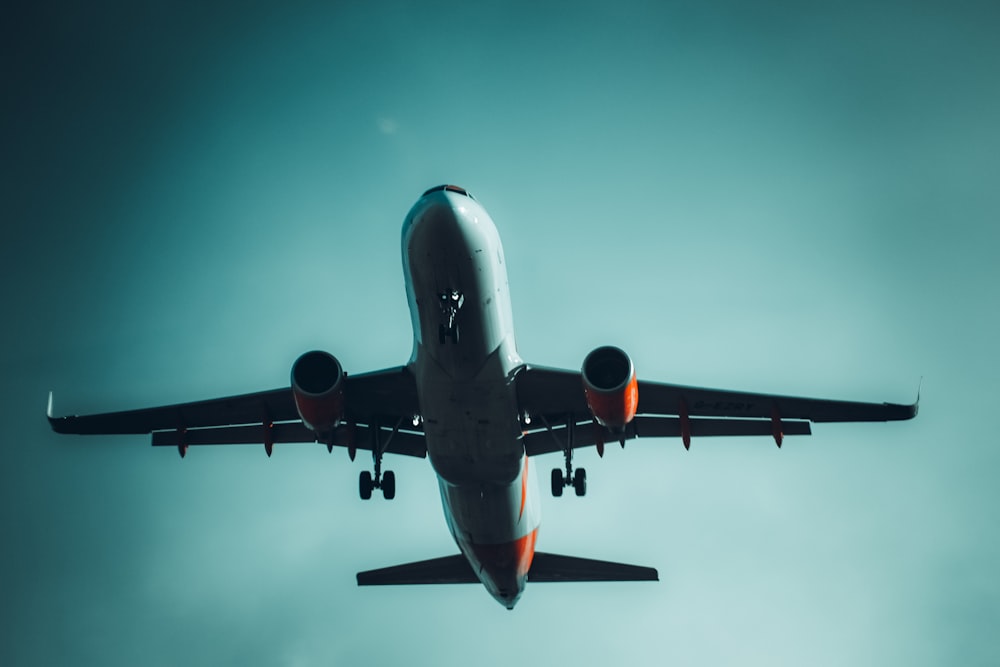 a large jetliner flying through a blue sky