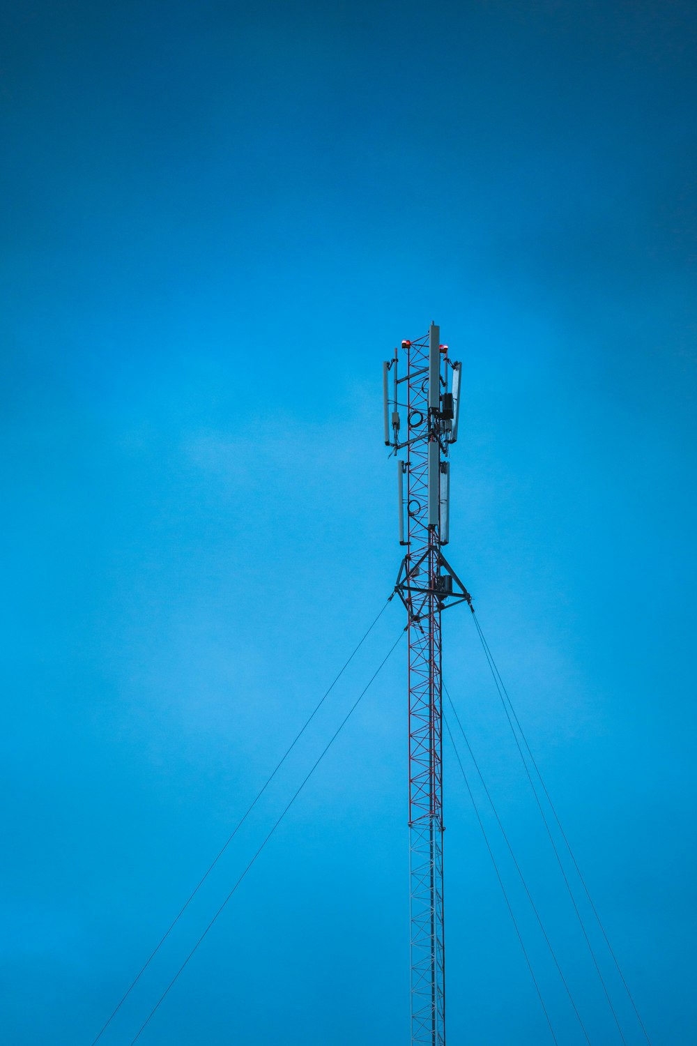 a tall tower with a cell phone on top of it