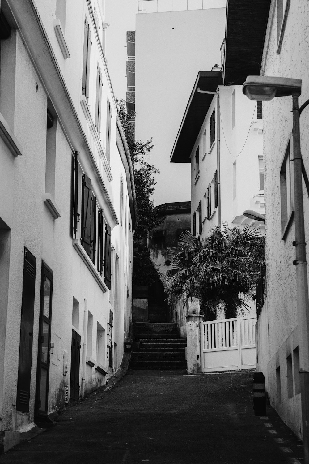 a black and white photo of a narrow street