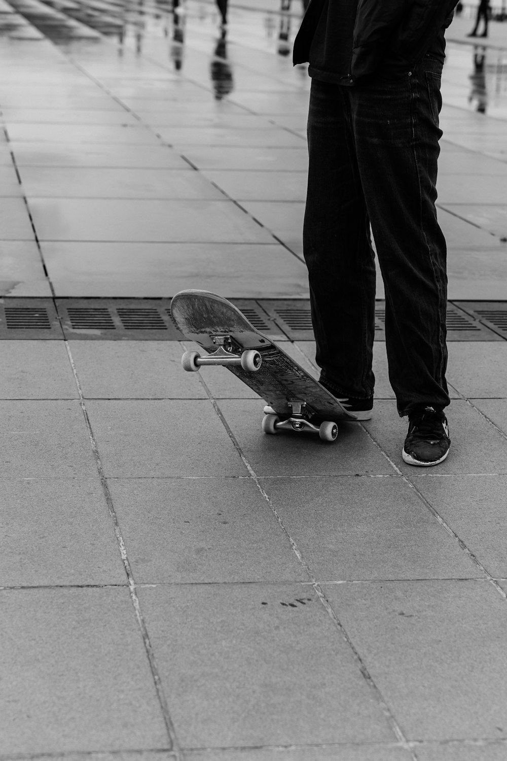 a person standing on a skateboard on a sidewalk