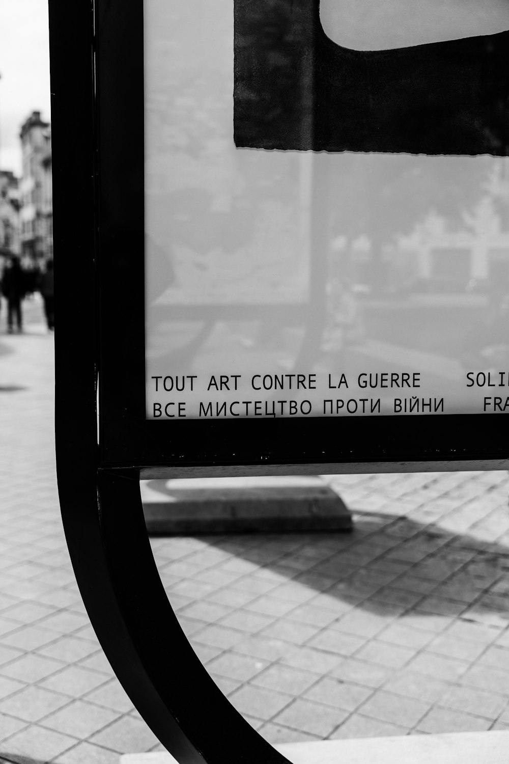 a black and white photo of a bus stop sign