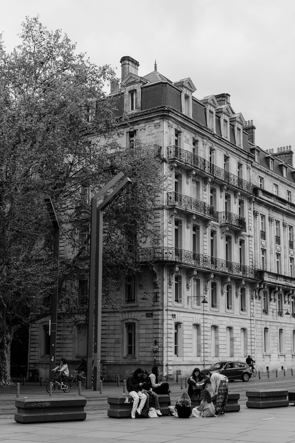 a group of people sitting outside of a building