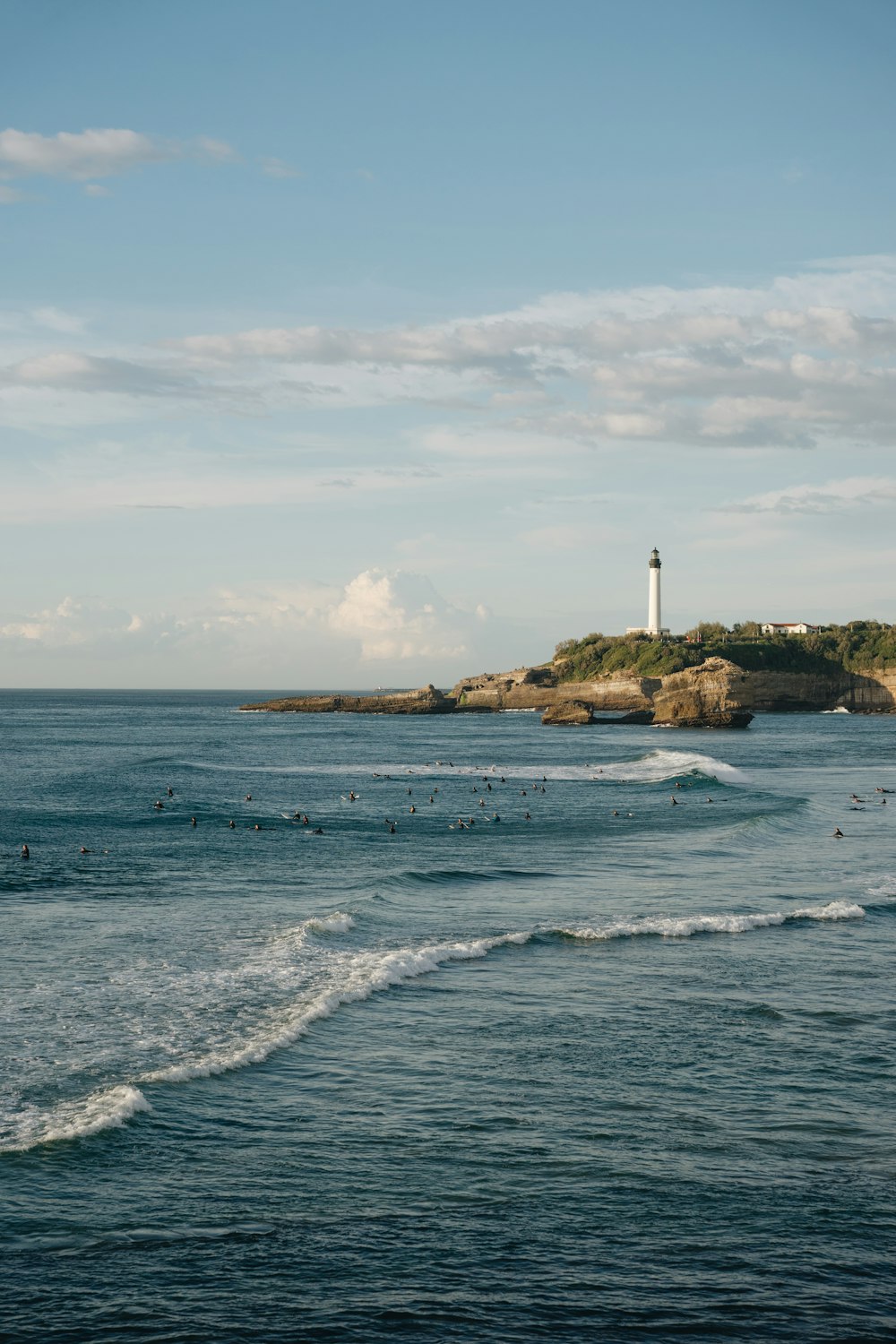 a body of water with a light house in the background