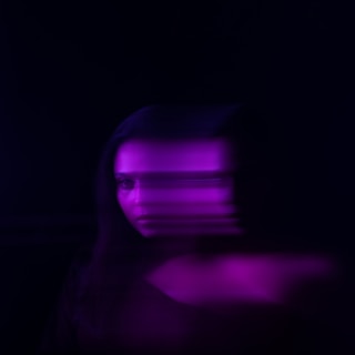 a blurry image of a woman's face in the dark