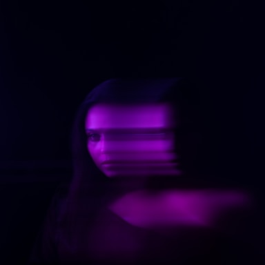 a blurry image of a woman's face in the dark
