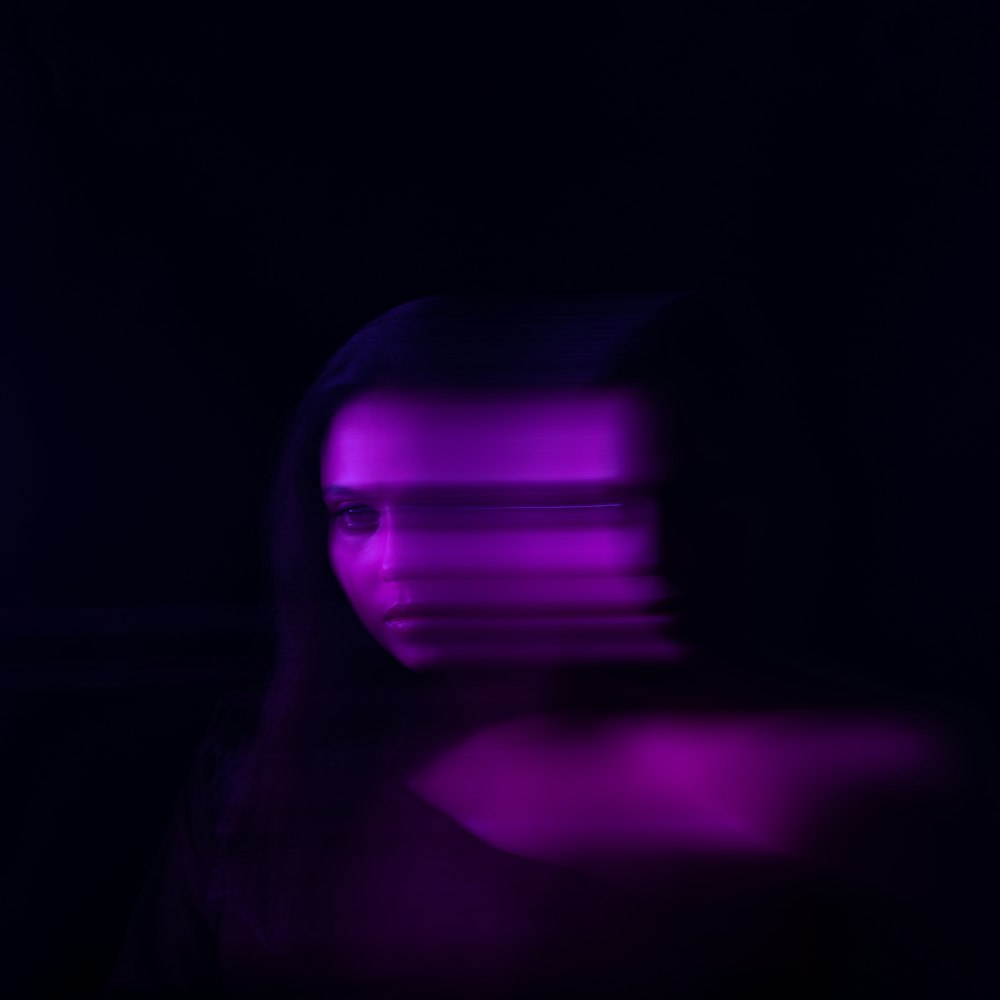 a blurry image of a woman's face in the dark