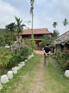 Consultant walking a property path with a homeowner, pointing out native species.