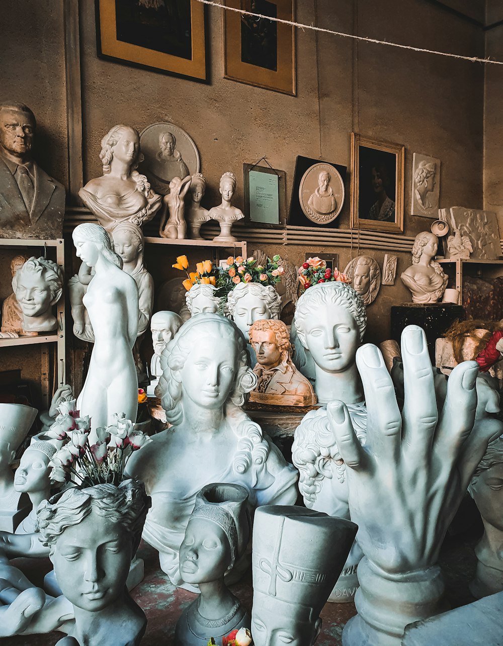 a room filled with lots of white statues