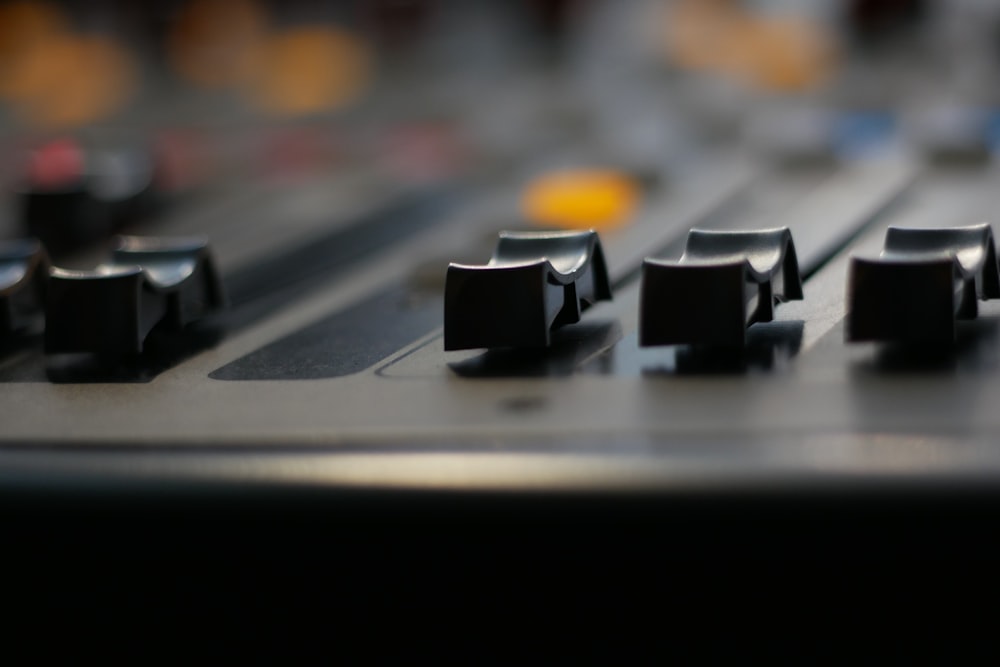 a close up of a sound board with knobs