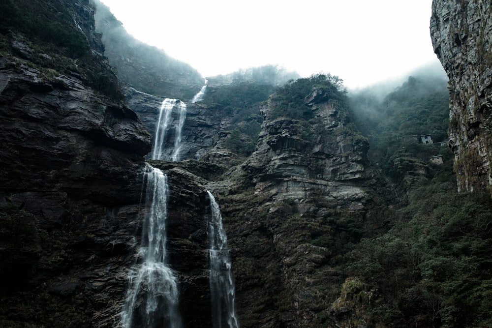 a waterfall in the middle of a mountain
