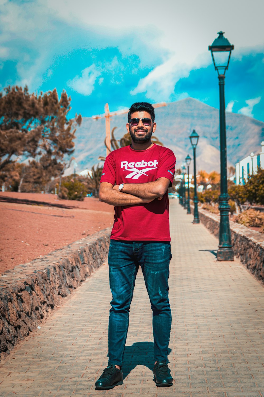 a man in a red shirt is posing for a picture