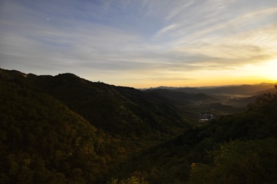 A scenic shot of Uganda’s rolling hills under a golden sunset.