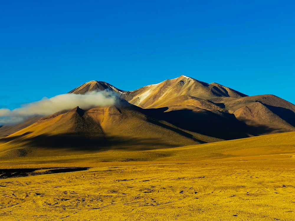 a mountain range with a cloud in the sky