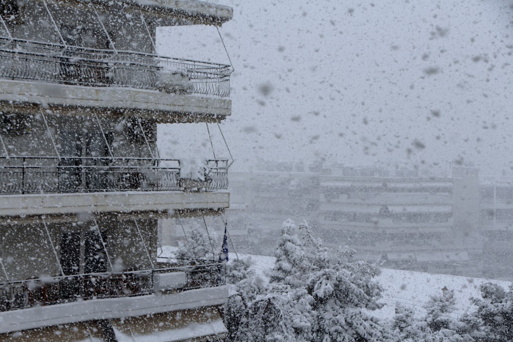 a building with a balcony and balcony balconies covered in snow