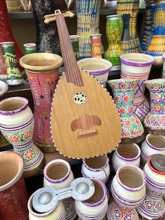 a wooden guitar sitting on top of a table