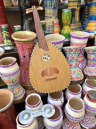 a wooden guitar sitting on top of a table