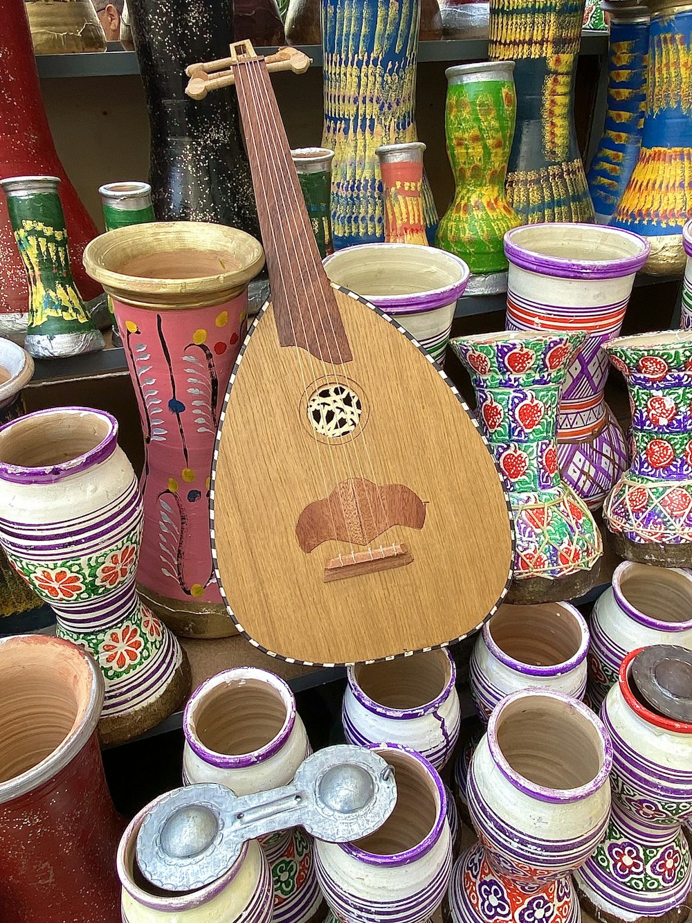 a wooden guitar sitting on top of a table