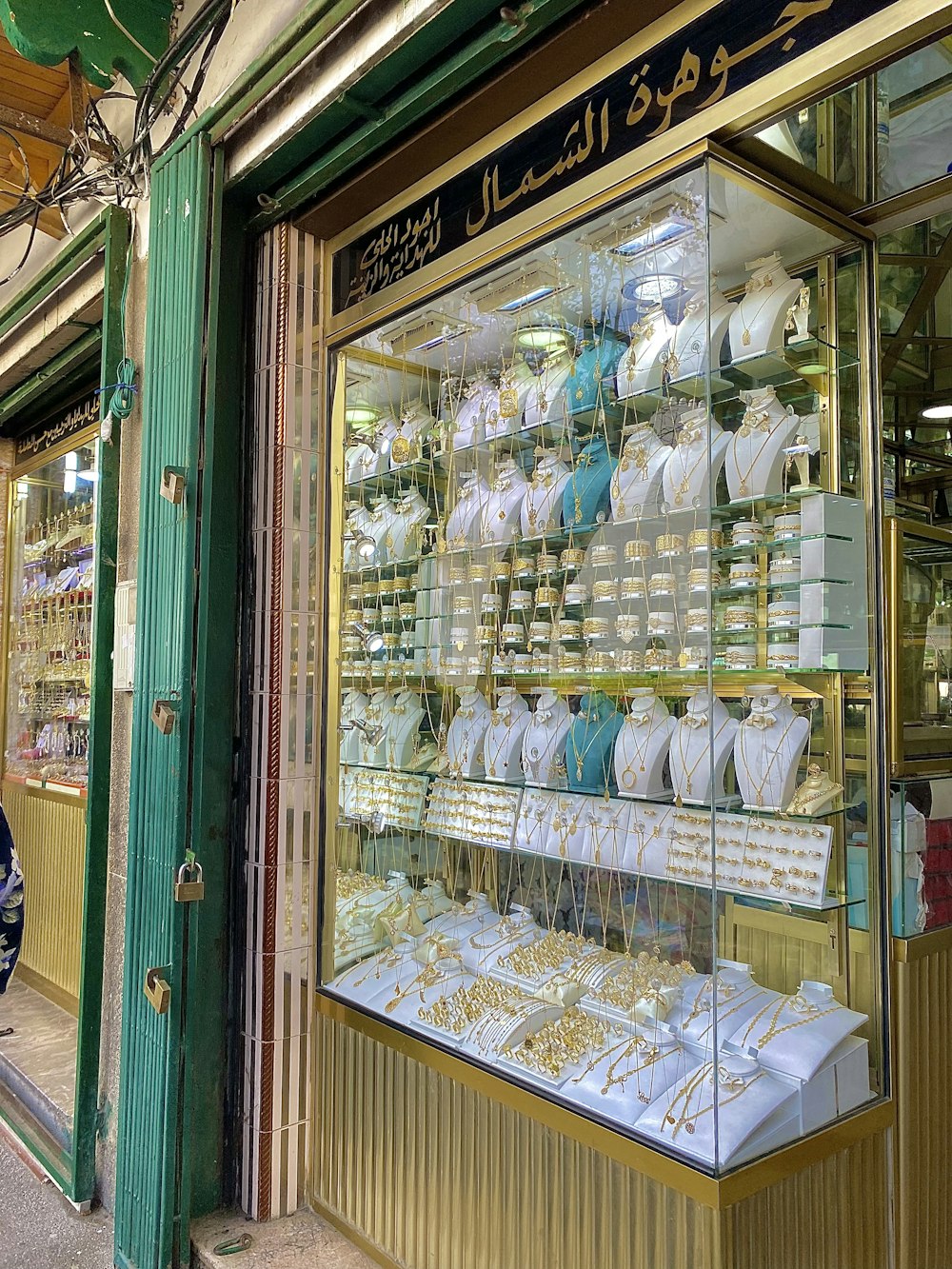 a store front with gold and white items on display