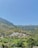 a scenic view of a village in the mountains